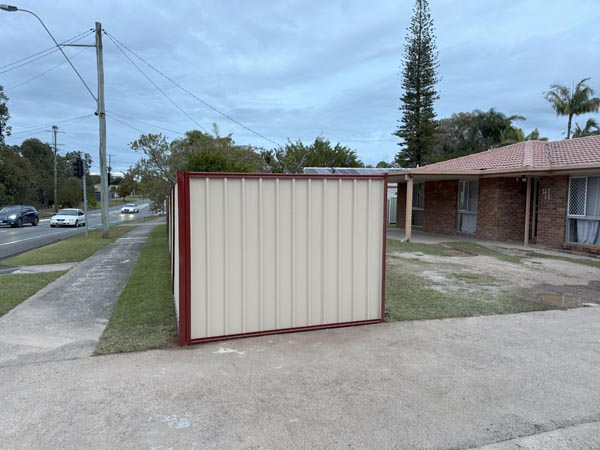 Manor red rails and posts on a Domain coloured panel Colorbond fence