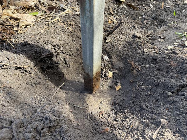 Steel galvanised post exhibited corrosion at it's base due to soil build up and depth from top of concrete pier