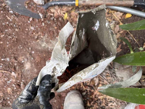 Using an empty waterproof concrete bag to wet mix a small portion of concrete