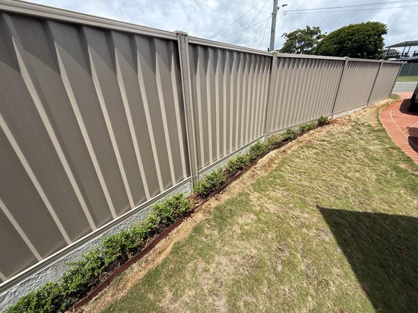 Concrete sleepers custom cut to sit inside an Oxworks upright post U-Channel